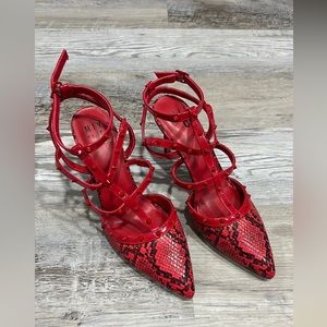 Red snakeskin high heels